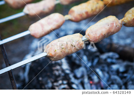 Delicious sausages on a skewer. Rest, friends, Delicious sausages on a skewer. Rest, friends, 64328149