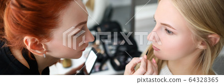 Female sitting in chair in saloon 64328365