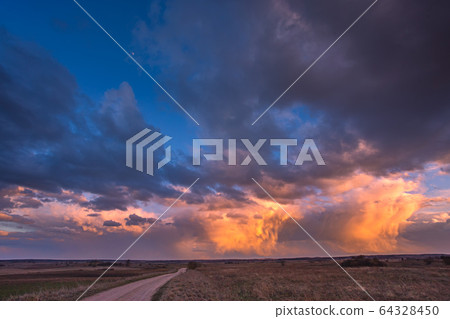 Path to cumulonimbus red storm clouds at sunset, beautiful landscape 64328450