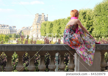 Beautiful young Parisian woman posing in Tuileries Garden 64328979