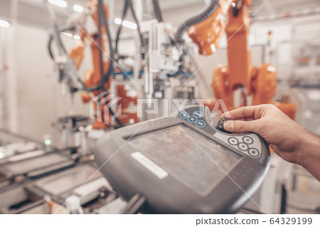 Engineer, technician working with automatic robot in automotive industrial, smart factory, automated workplace Engineer, technician working with automatic robot in automotive industrial, smart factory, automated workplace 64329199