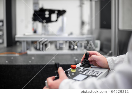 Quality engineer measuring some moldings by professional 3D measuring system machine, industrial concept 64329211