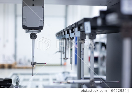 Close up of professional automatic 3D measuring system machine for plastic moldings, industrial and automotive concept Close up of professional automatic 3D measuring system machine for plastic moldings, industrial and automotive concept 64329244