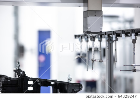 Close up of professional automatic 3D measuring system machine for plastic moldings, industrial and automotive concept Close up of professional automatic 3D measuring system machine for plastic moldings, industrial and automotive concept 64329247