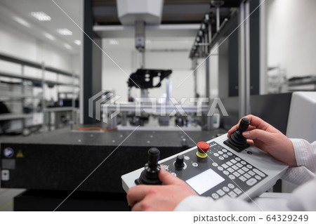 Quality engineer measuring some moldings by professional 3D measuring system machine, industrial concept Quality engineer measuring some moldings by professional 3D measuring system machine, industrial concept 64329249