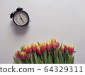 Red and yellow tulips with number eight. Top view of the white background of the spring composition. 64329311