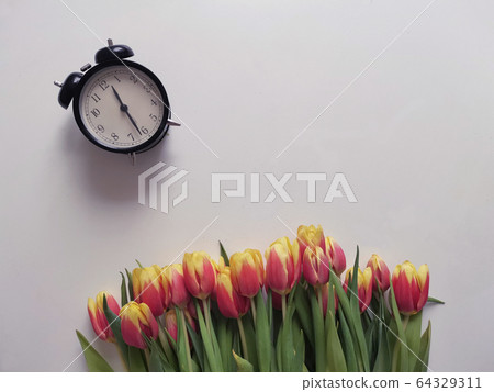 Red and yellow tulips with number eight. Top view of the white background of the spring composition. 64329311
