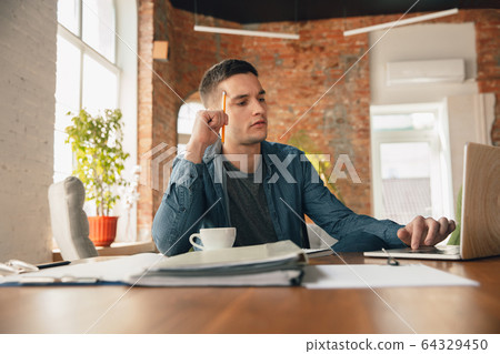 Creative workplace - organized work space as you like for inspiration, man working in office with pencil and papers Creative workplace - organized work space as you like for inspiration, man working in office with pencil and papers 64329450
