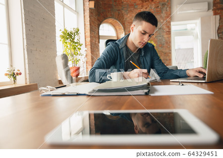 Creative workplace - organized work space as you like for inspiration, man working in office with pencil and papers Creative workplace - organized work space as you like for inspiration, man working in office with pencil and papers 64329451