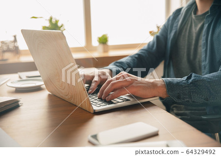 Creative workplace - organized work space as you like for inspiration, man working in office surrounded by gadgets, papers Creative workplace - organized work space as you like for inspiration, man working in office surrounded by gadgets, papers 64329492