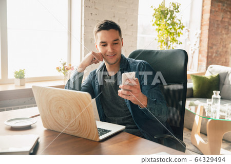 Creative workplace - organized work space as you like for inspiration, man working in office surrounded by gadgets, papers Creative workplace - organized work space as you like for inspiration, man working in office surrounded by gadgets, papers 64329494