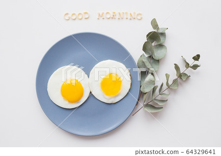 two beautiful eggs on a plate 64329641
