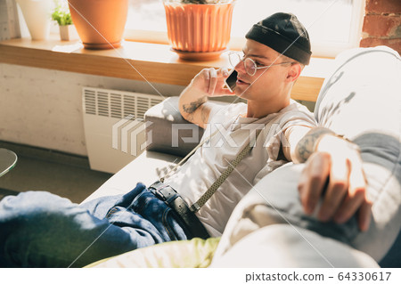 Young man studying at home during online courses or free information by hisself, online school 64330617