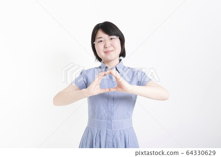 A woman giving an OK sign A woman giving an OK sign 64330629