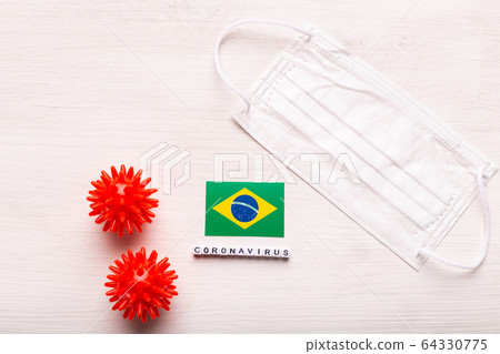 Coronavirus 2019-nCoV concept. Top view protective breathing mask and flag of Brazil. Novel Chinese Coronavirus outbreak. Coronavirus 2019-nCoV concept. Top view protective breathing mask and flag of Brazil. Novel Chinese Coronavirus outbreak. 64330775
