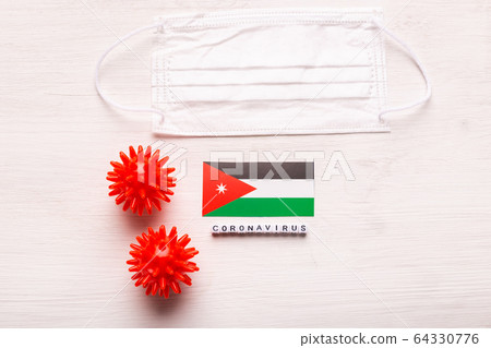 Coronavirus 2019-nCoV concept. Top view protective breathing mask and flag of Jordan. Novel Chinese Coronavirus outbreak. Coronavirus 2019-nCoV concept. Top view protective breathing mask and flag of Jordan. Novel Chinese Coronavirus outbreak. 64330776