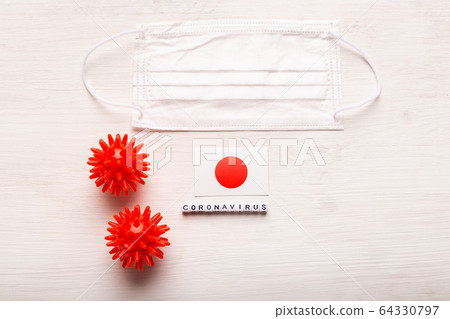 Coronavirus 2019-nCoV concept. Top view protective breathing mask and flag of Japan. Novel Chinese Coronavirus outbreak. 64330797