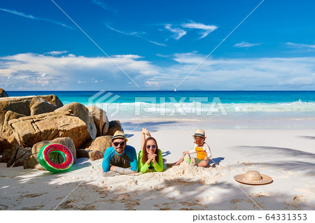 Family with three year old boy on beach Family with three year old boy on beach 64331353