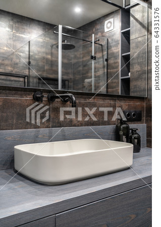 Interior of luminous modern bathroom with bronze walls 64331576