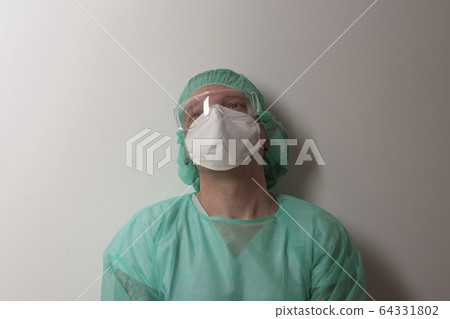 Tired male nurse, with plastic protective eyeglasses Tired male nurse, with plastic protective eyeglasses 64331802