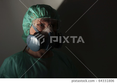 Male nurse, with  protective equipment to protect against the virus covid-19 in ICU in hospital. 64331806