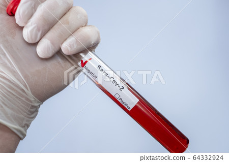 The virologist is holding a test tube with a blood sample infected with a coronovirus. Test for COVID-19 virus in the blood. Laboratory studies of bacteriological weapons. Pandemic SARS-CoV-2 64332924