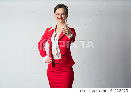 Businesswoman showing thumbs up 64332975
