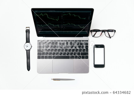 Top view white office desk with laptop, smart phone and supplies, flat lay. 64334682
