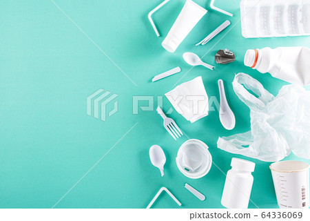 Top view of Different garbage materials on green Top view of Different garbage materials on green 64336069