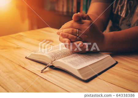 Christian hand while praying and worship for 64338386