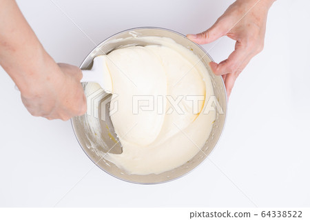Making sweets at home Sponge dough making process Mixing dough with a spatula Making sweets at home Sponge dough making process Mixing dough with a spatula 64338522