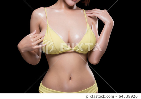 Close up of female big natural breasts. Isolated 64339926