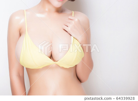 Close up of female big natural breasts. Isolated 64339928