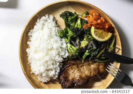 Plate of pork saute and salad Plate of pork saute and salad 64341517