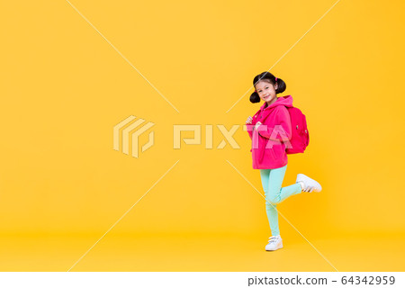 Excited cute girl with pigtail hair going to school  64342959