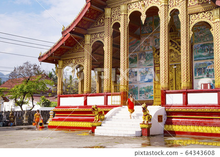 Wat Manorom, a boy monk cleaning 64343608