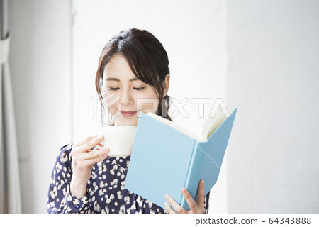 Young woman reading a book at home Young woman reading a book at home 64343888