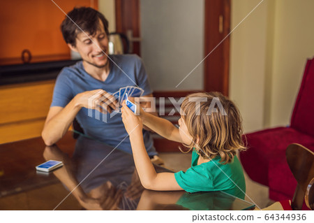 Happy Family Playing Board Game At Home 64344936