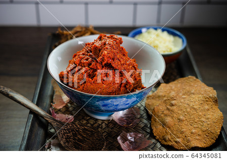 ingredient of thai spicy soup in ceramic bowl. ingredient of thai spicy soup in ceramic bowl. 64345081
