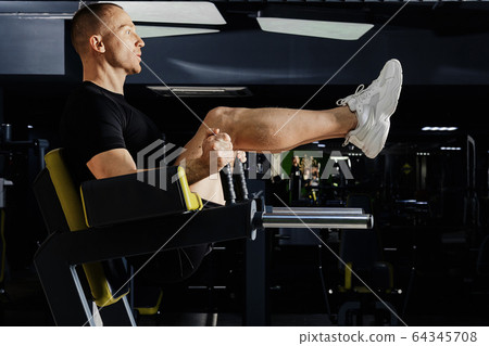 Muscular man pumping press in gym Muscular man pumping press in gym 64345708