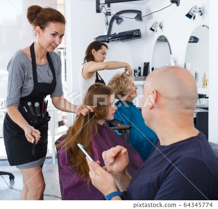 Teenage girl with father in hair salon Teenage girl with father in hair salon 64345774