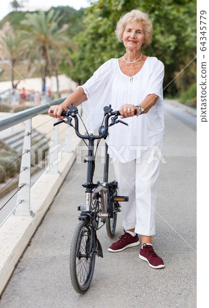 Elderly woman going to biking Elderly woman going to biking 64345779