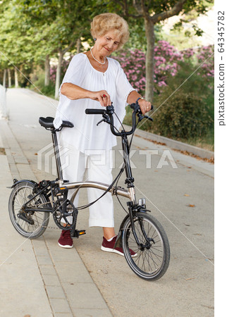 Elderly woman going to biking Elderly woman going to biking 64345782
