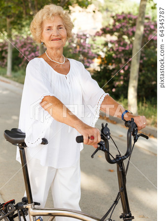 Elderly woman going to biking Elderly woman going to biking 64345787