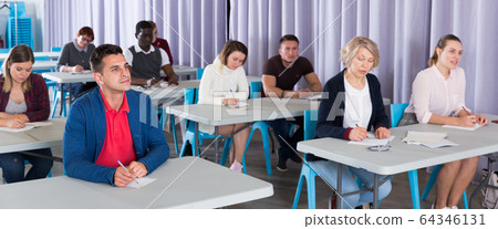 Adult students listening in classroom Adult students listening in classroom 64346131