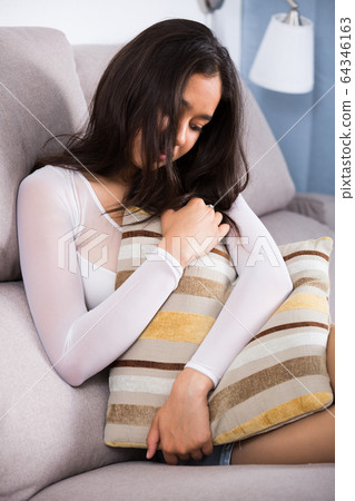 sad female sitting with pillow sad female sitting with pillow 64346163