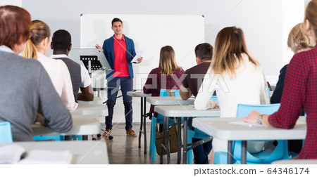 Male student answering at whiteboard Male student answering at whiteboard 64346174