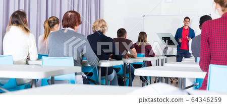 Students with teacher studying in classroom 64346259