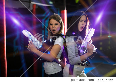 Girls back to back in colorful laser beams Girls back to back in colorful laser beams 64346266