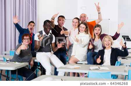 Cheerful adult students in auditorium Cheerful adult students in auditorium 64346268